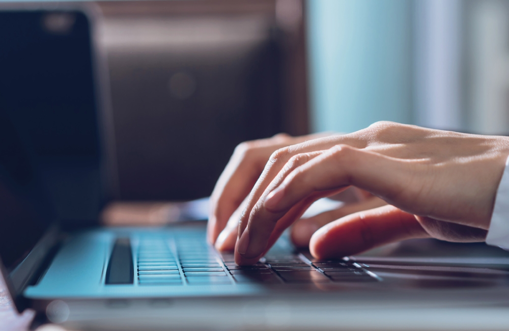 Close up of business woman hands typing on laptop computer and searching web, browsing in the workplace at office. proportion of the banner for advertisement.
